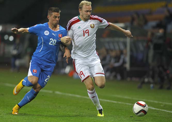 Slovakia's Robert Mak (left) vies for the ball against Belarus' Maksim Bordachev during their group C qualifying soccer match for the Euro 2016 in Borisov, Belarus on Sunday.