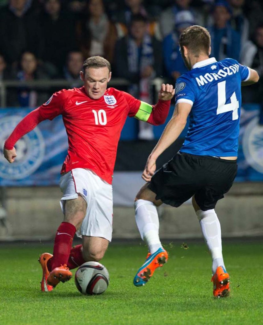 Estonia's Igor Morozov (right) fights for the ball with England's Wayne Rooney during the Euro 2016 qualifying match between Estonia and England in Tallinn, Estonia on Sunday.