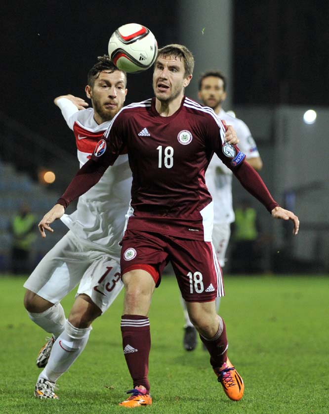 Latvia's Aleksandrs Fertovs (right) fights for the ball with Turkey's Buyuk Adem during the Euro 2016 Group A qualifying soccer match between Latvia and Turkey in Riga, Latvia on Monday.