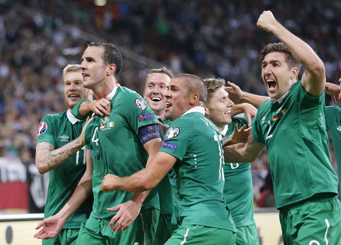 Ireland's players celebrate after scoring during the Euro 2016 group D qualifying soccer match between Germany and Ireland in Gelsenkirchen, Germany on Tuesday.
