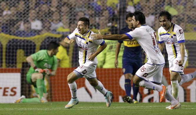 Oscar Ruiz of Paraguay's Capiata (left) celebrates after Argentina's Boca Juniors Lisandro Magallan scored an own goal during a Copa Sudamericana soccer match in Buenos Aires, Argentina on Wednesday.
