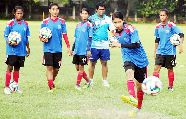 Members of Bangladesh Under-16 National Women's Football team stretching during their practice session at the BUET Ground on Saturday.