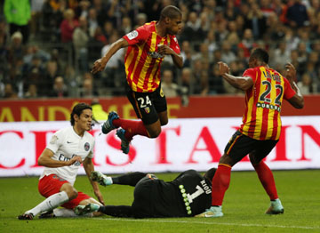 Lens goalkeeper Rudy Riou (second right) dives for the ball while PSG's Edinson Cavani (left Lens Ludovic Baal (second left) and Lens' Loick Landre (right) look on during their League One soccer match between Lens and Paris Saint Germain at Stade de Fr