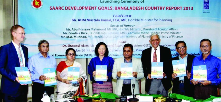 Planning Minister AHM Mostofa Kamal along with other distinguished guests at the launching ceremony of 'SAARC Development Goals: Bangladesh Country Report-2013' at the NEC Conference Center of the Planning Commission in the city on Sunday.
