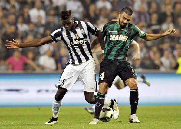 Sassuolo's Francesco Magnanelli (right) vies for the ball with Juventus's Paul Pogba, during their Serie A soccer match at Reggio Emilia's Mapei stadium, Italy on Saturday.