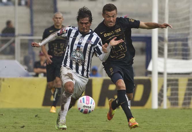 Pachuca's Jorge Hernandez, fights for the ball with Pumas' Dante Lopez during a Mexican soccer league match in Mexico City on Sunday.