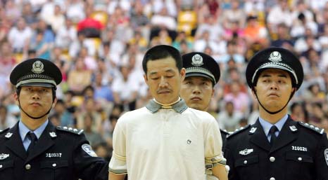 A Chinese drug dealer is sentenced to death by a judge during a public trial at a university gymnasium.