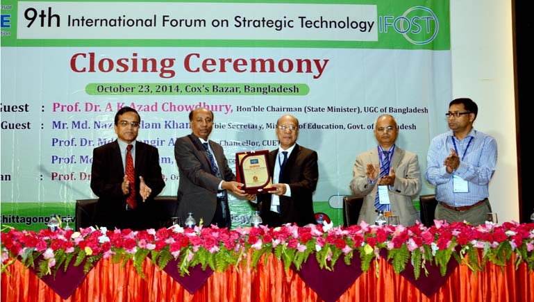 Prof Dr AK Azad Chowdhury, Chairman , University Grant Commission being presented a crest at the closing ceremony of the 9th International Forum on Strategic Technology at Cox'sBazar on Thursday.