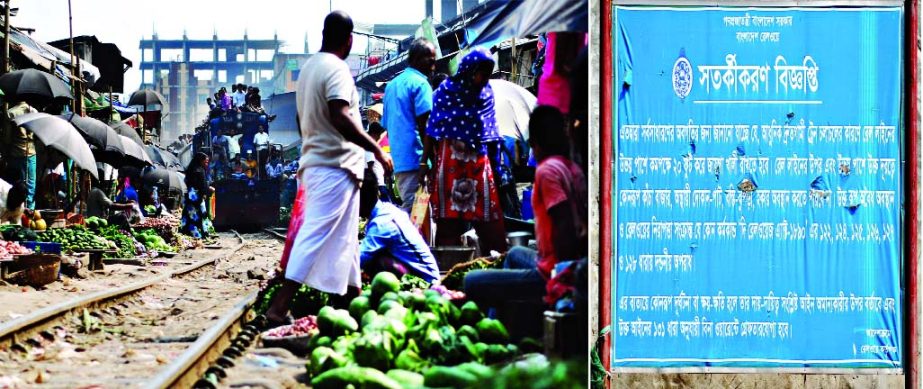 Makeshift shops sprang up again on both sides of Railway lines in the city despite written warning (right) displayed in the area by the authorities'. This photo was taken from Narayanganj Railway Gate-2 on Saturday.