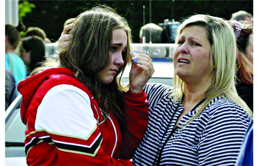 A girl is comforted at a church, where students were taken to be reunited with parents following a shooting at Marysville Pilchuck High School in Marysville last Friday. Internet photo