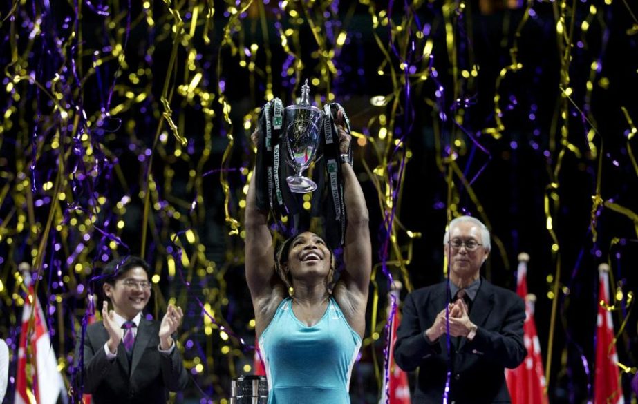 Serena Williams of the US holds her trophy aloft after defeating Romania's Simona Halep in the singles final at the WTA tennis finals in Singapore on Sunday.