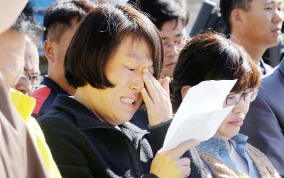 An unidentified family member of passengers aboard the sunken ferry Sewol cries as she demands maximum punishment to be sentenced on the crew members of the ferry during their trial at Gwangju District Court in Gwangju, South Korea.