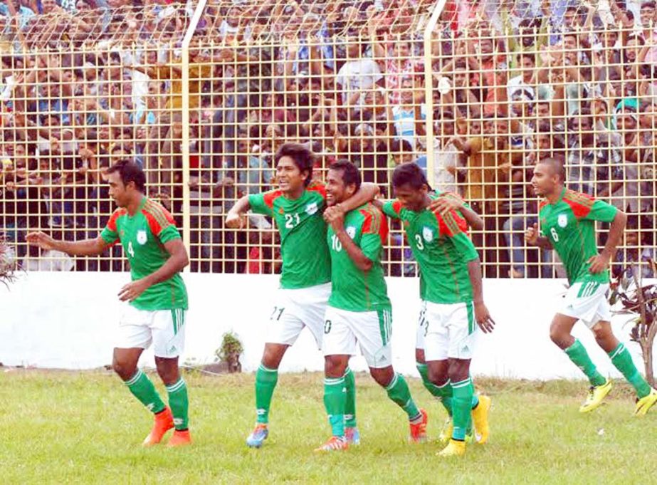 Players of Bangladesh National Football team celebrate after beating Sri Lanka National Football team in a FIFA international friendly football match at the Muktijoddha Smriti Stadium in Rajshahi on Monday.
