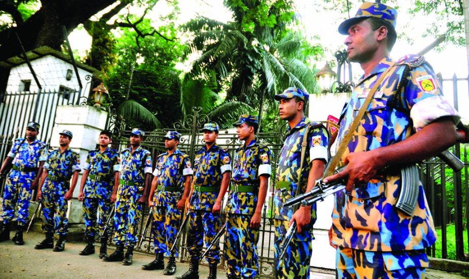 Law enforcers stand guard at the entrance of International Crimes Tribunal centering verdict on Jamaat-e-Islami Ameer Matiur Rahman Nizami today. The snap was taken on Tuesday.