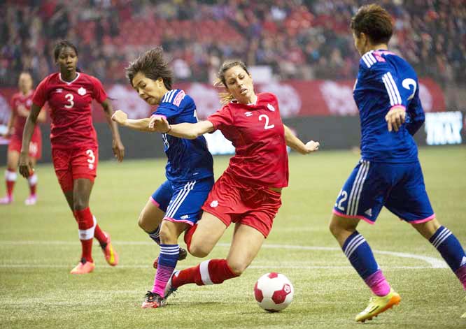 Team Canada's Emily Zurrer (second from right) fights for control of the ball with team Japan's Mana Iwabuchi, (second from left) as Canada's Kadeisha Buchanan (left) and Japan's Yuika Sagasawa (right) look on during the first half International frien