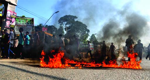 Supporters of Jamaat-Shibir staged demonstration and set fire on city streets by pouring patrol against protesting ICT verdict of Matiur Rahman Nizami. This photo was taken from cityâ€™s Jurain area on Wednesday.