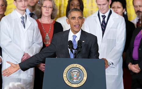 President Barack Obama gestures during remarks at an event with American health care workers fighting the Ebola virus, in the East Room of the White House in Washington