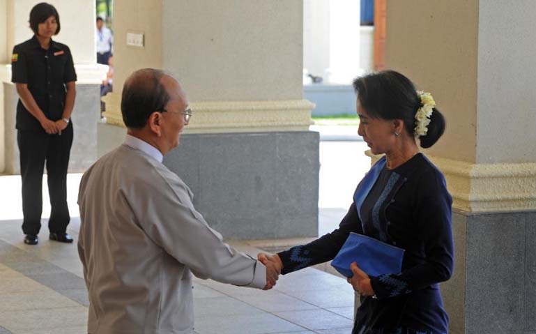 Myanmar President Thein Sein (L) greets Aung San Suu Kyi, Chairman of National League for Democracy (NLD) and lower house member of Parliament, prior to their meeting at the Persident's office in Naypyidaw on Friday.