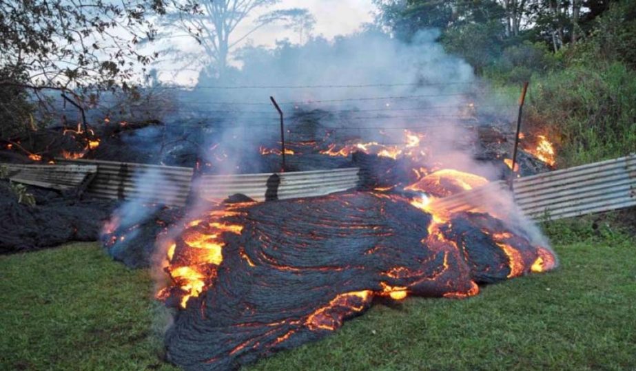 The lava flow from the Kilauea Volcano burns vegetation as it approaches a property boundary in a US Geological Survey image taken near the village of Pahoa.