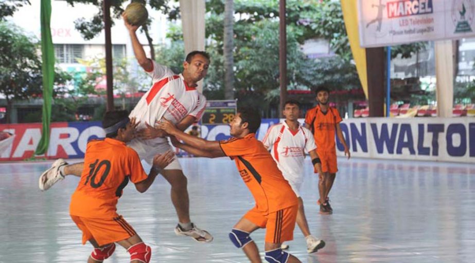 An action from the match of the Marcel LED Television First Division Handball League between Flame Boys Club and Satirtha Club at the Shaheed (Captain) M Mansur Ali National Handball Stadium on Saturday.