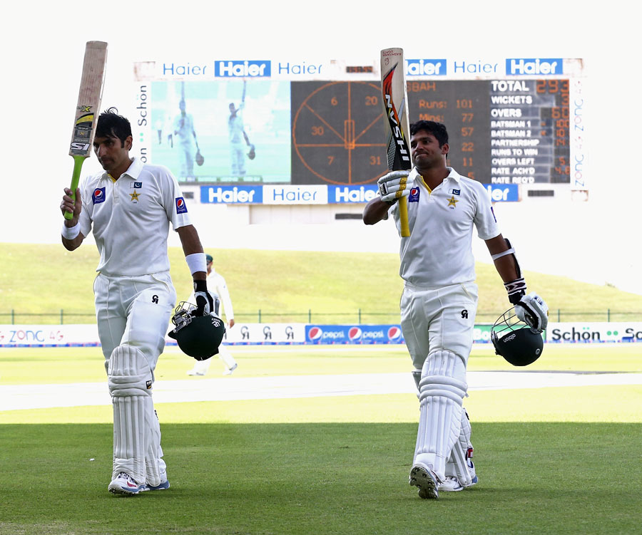 Misbah-ul-Haq and Azhar Ali walk off after scoring tons on the 4th day of 2nd test between Pakistan and Australia at Abu Dhabi on Sunday.