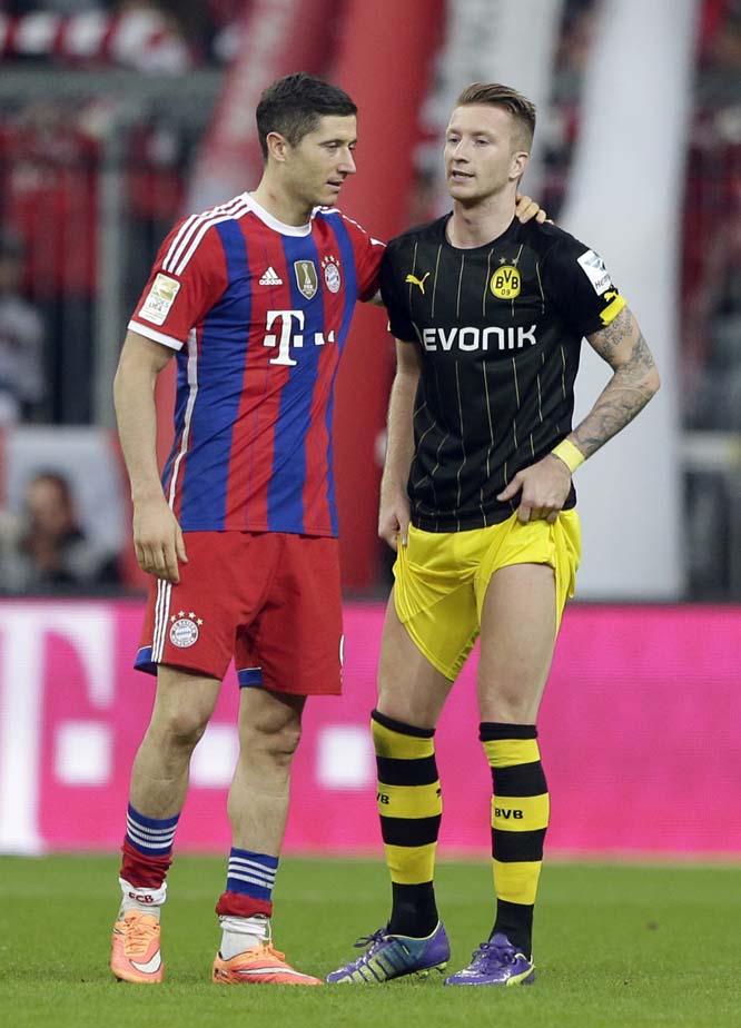 Bayern's Robert Lewandowski from Poland (left) comforts Dortmund's Marco Reus after the German first division Bundesliga soccer match between FC Bayern and Borussia Dortmund in the Allianz Arena in Munich, Germany on Saturday. Bayern Munich won 2-1.