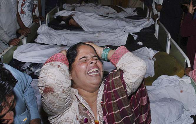 A woman mourns for her relative next to the bodies of the blast victims at a hospital in Lahore, Pakistan.