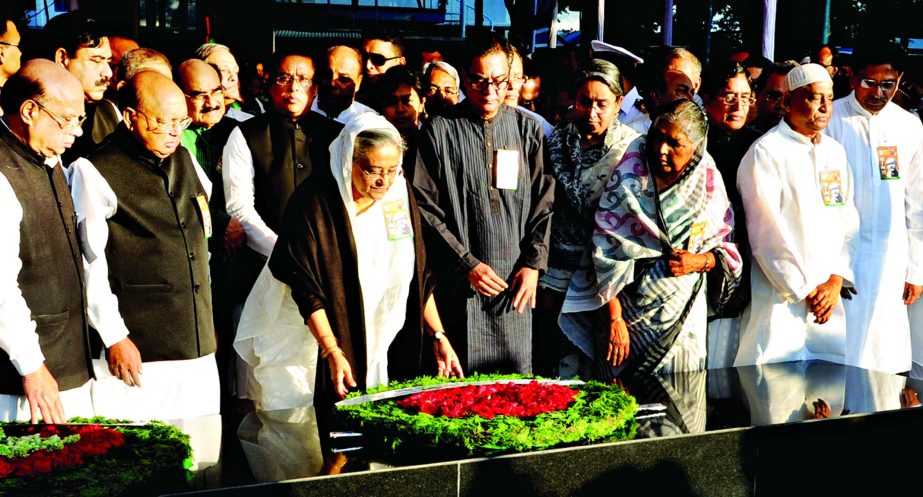 Marking the 39th Jail Killing Day Prime Minister Sheikh Hasina alongwith party leaders placing wreaths at the portrait of Bangabandhu Sheikh Mujibor Rahman in front of Bangabandhu Bhaban on Monday .