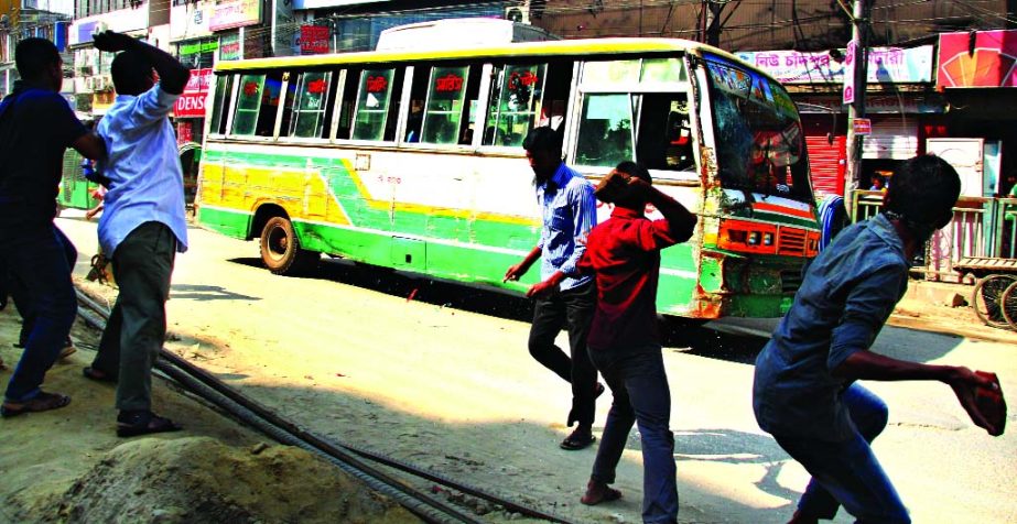 A passenger bus being vandalised by the activists of Jamaat-Shibir in city's Malibagh area during hartal hours on Monday.