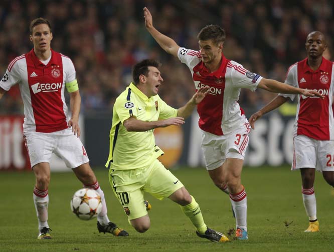 Barcelona's Lionel Messi is tackled by Ajax's Joel Veltman before getting a red card during the Group F Champions League match between AFC Ajax and FC Barcelona at ArenA stadium in Amsterdam, Netherlands on Wednesday.