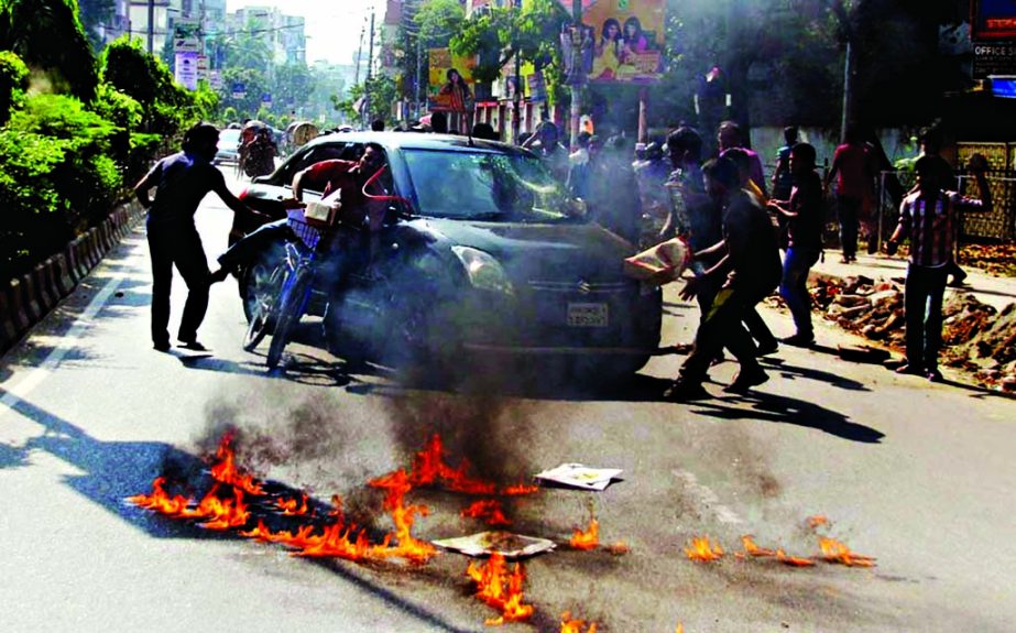 Jamaat-Shibir pickets set the fire on the street and vandalise private cars during the 2nd day of 48-hr hartal. This photo was taken from Dhanmondi area on Thursday.