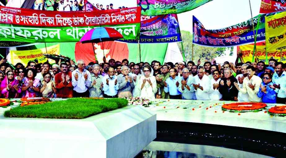 BNP Chairperson Begum Khaleda Zia along with party leaders and activists offering munajat after placing floral wreaths at the Mazar of Shaheed President Ziaur Rahman in the city on Friday marking National Revolution and Solidarity Day.