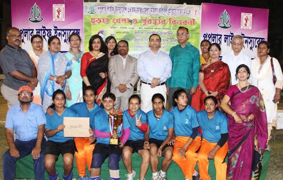 Rajshahi District team, the winners of the Popular Life Insurance Inter-District Women's Volleyball Competition and the guests and officials of Bangladesh Volleyball Federation pose for a photo session at the Dhaka Volleyball Stadium on Friday.