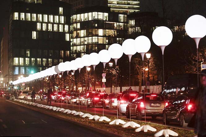 Illuminated white balloons, seen here near the Brandenburg Gate, mark the route of the Berlin Wall.
