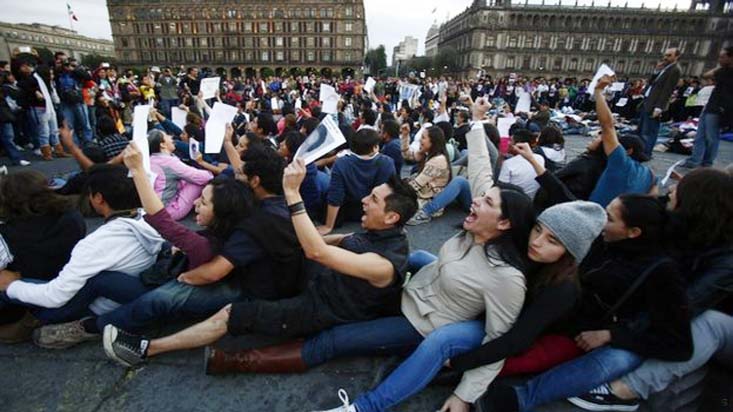 Demonstrators support the families of the missing students in the main square in Mexico City on Saturday.