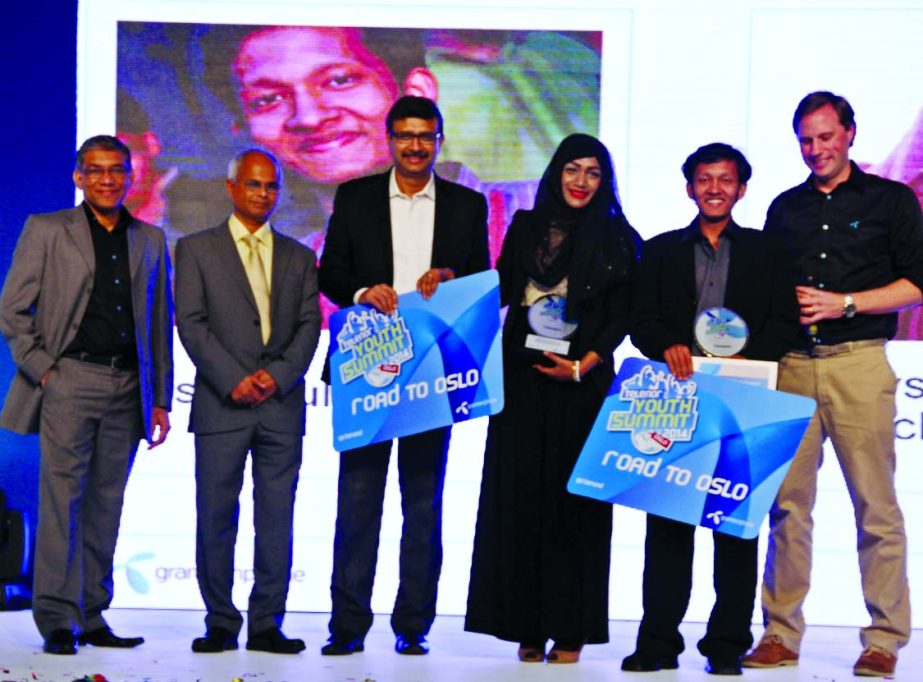 Education Secretary NI Khan distributing prizes between the winners of "Telenor Youth Summit 2014"" at a city hotel on Saturday. Grameenphone CEO Vivek Sood and Chief Human Resources Officer Quazi Mohammad Shahed were present."