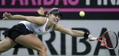 Germany's Angelique Kerber returns a ball to Czech Republic's Petra Kvitova during their Fed Cup Final tennis match between Czech Republic and Germany in Prague, Czech Republic on Sunday.