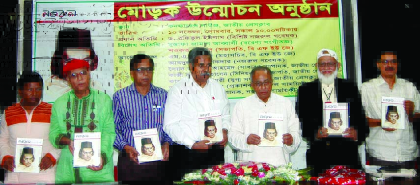 Nazrul Researcher and Chairman of Nazrul Institute Trustee Board Dr Rafiqul Islam along with other distinguished guests holds the copies of magazine 'Nazrul Samoeeki' at its cover unwrapping ceremony at the National Press Club on Monday.