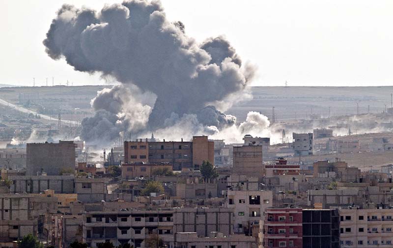 Smoke rises over the Syrian city of Kobani, following a US led coalition airstrike, seen from outside Suruc, on the Turkey-Syria border.