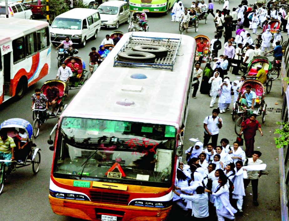 BRTA's countrywide drive against unfit vehicles from Monday led to acute shortage of transports in city causing immense sufferings to commuters including school children on Tuesday. This photo was taken from in front of Notre Dame College.