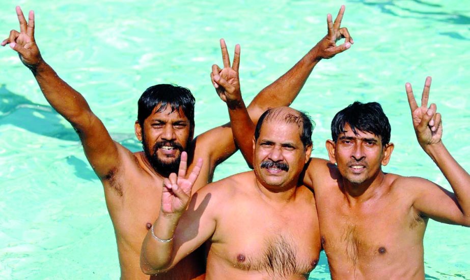 Nur Hoossain Pipul (centre), Abdul Aleem Shahin (right) and Khorshed Alam Rinku (left), who finished first, second and third respectively in the Swimming Competition of the Walton Photo Journalists' Sports Festival held at the Ivy Rahman National Swimmi