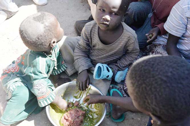 Children eat in a camp for Nigerian refugees in Minawao, in the extreme north-west of Cameroon.