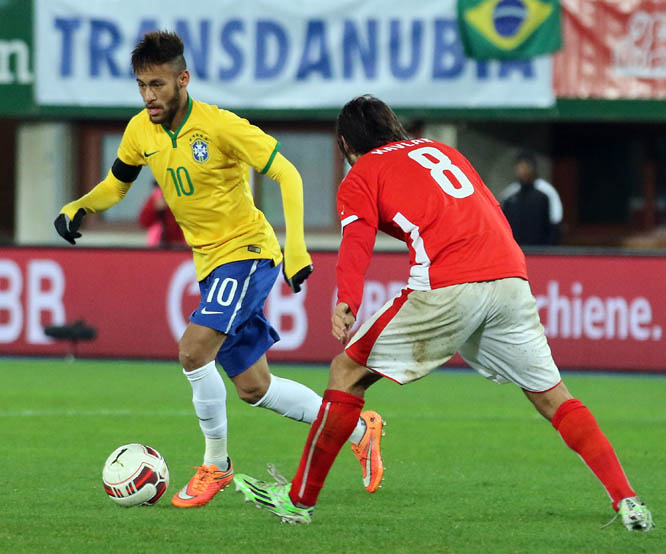 Brazil's Neymar (left) and Austria's Veil Kavlak challenge for the ball during an International friendly soccer match between Austria and Brazil in Vienna, Austria on Tuesday.