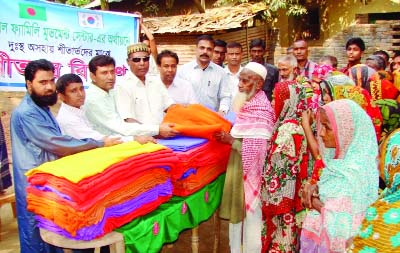 BOGRA: Members of Global Family Movement Centre Korea-Bangladesh distributing blankets among poor and disabled people at Mahasthangarh village on Thursday morning.