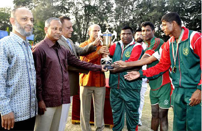 Major General Sabbir Ahmed, GOC, 24 Infantry Division handing over the champions trophy to Bangladesh Army team, which won Inter-Services Volleyball title at BAF Base Zahurul Haque, Chittagong on Thursday.