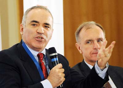 Russian chess master and political activist Garry Kasparov, left, speaks at the Warsaw Security Forum, as Poland's former Defense Minister Bogdan Klich, right, listens, in Warsaw, Poland on Thursday.