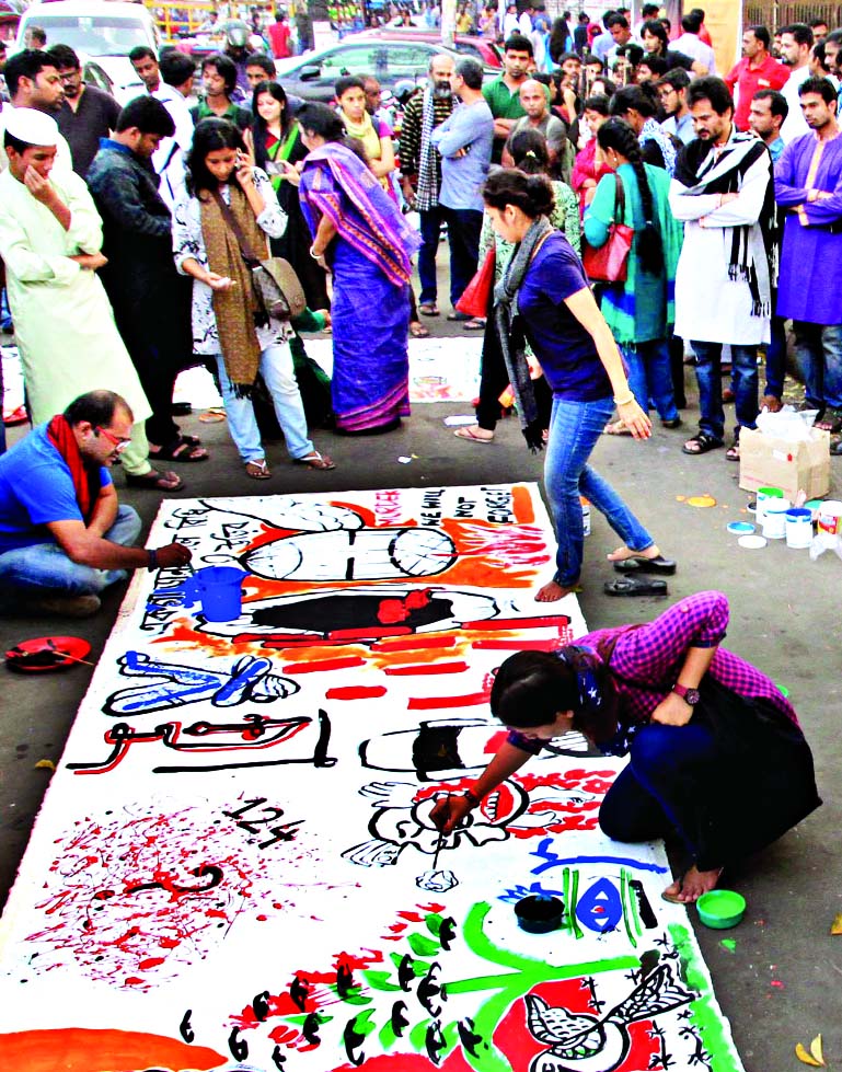 IN MEMORIUM: Various organisations arranged programmes at Shahbagh intersection on Friday demanding punishment to the culprits of devastating fire that killed about 113 Tazrin Fashions workers two years ago.