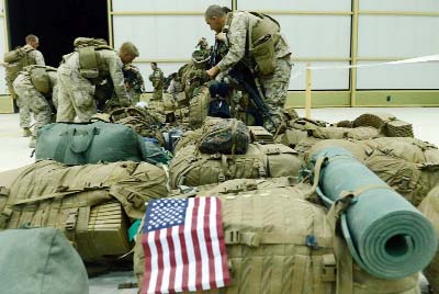 US Marines arrange their equipment as US troops arrive in Kandahar after their withdrawl from the Camp Bastion-Leatherneck complex in Helmand province