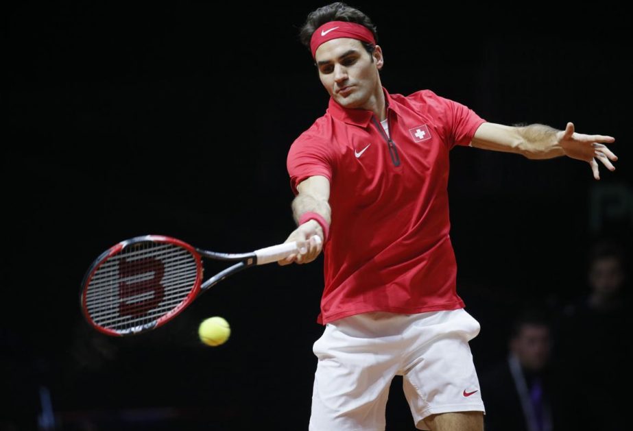Switzerland's Roger Federer returns the ball to France's Gael Monfils during their Davis Cup final singles tennis match at the Pierre-Mauroy stadium in Villeneuve d'Ascq, near Lille on Friday.