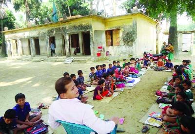 PATUAKHALI: Students of Kalapara Govt Primary School attending their classes under the open sky as their school building has been damaged. This picture was taken on Saturday.